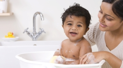 A mom giving her baby a bath